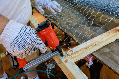 An image of a person working on a fence installation service