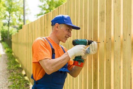 An image of a person building a fence 